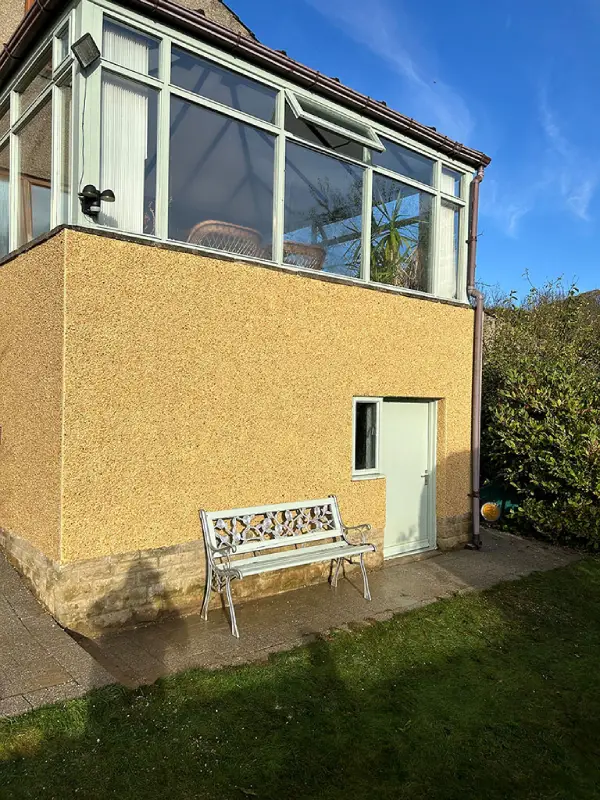 Derbyshire spa on cream pebble dashing - Silsden