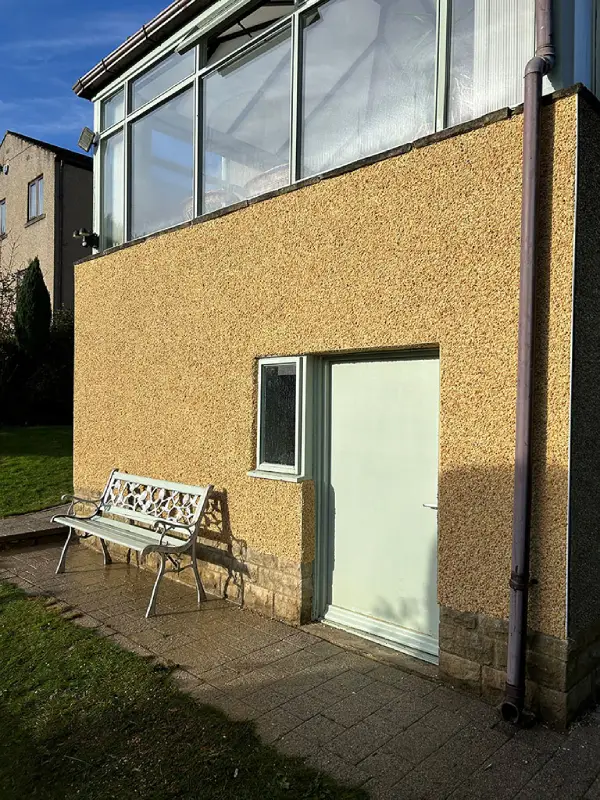 Derbyshire spa on cream pebble dashing - Silsden